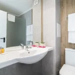Bathroom with large mirror and shower